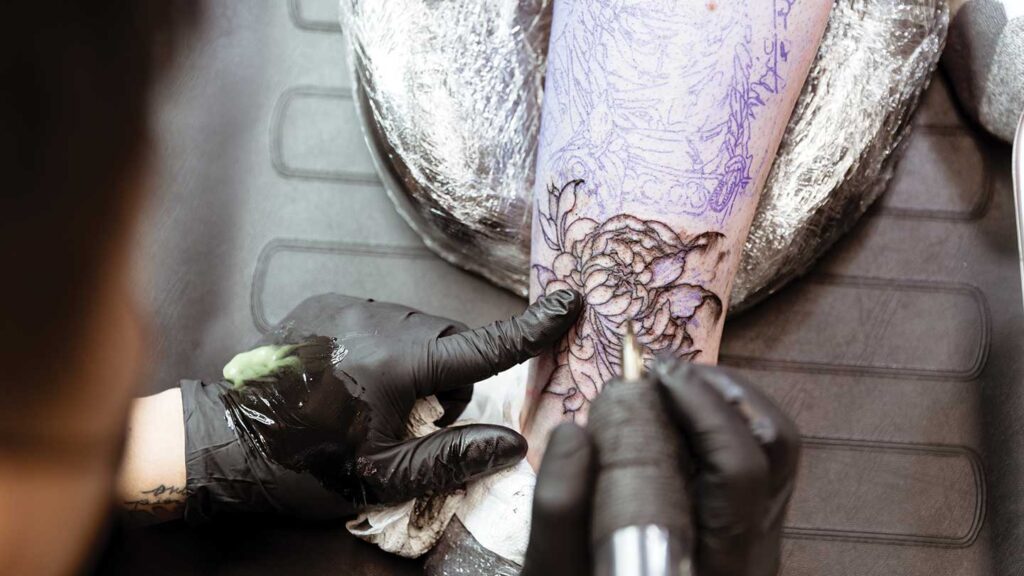 Flower tattoo artist tattooing