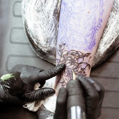 Tattoo artist tattooing flowers